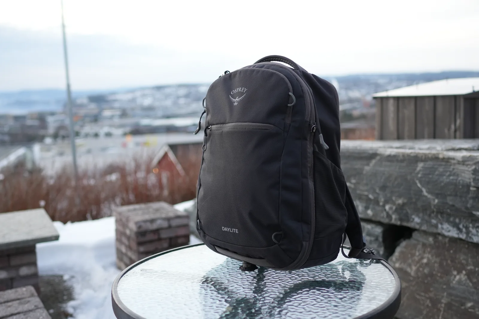 Osprey Daylite 26+6 backpack front three-quarter view on snowy surface