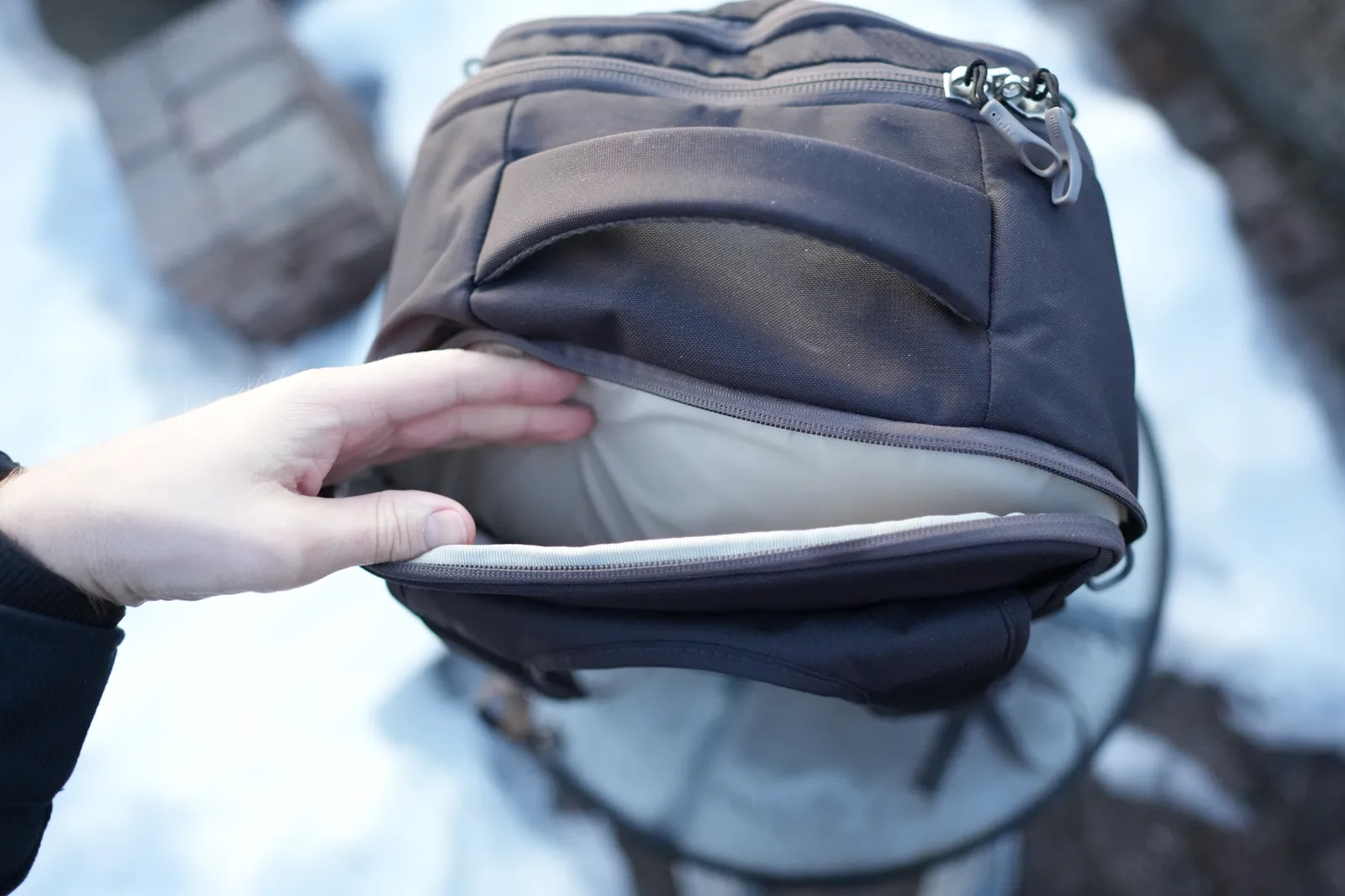 Osprey Daylite 35 laptop sleeve open showing the padded compartment with a laptop inside