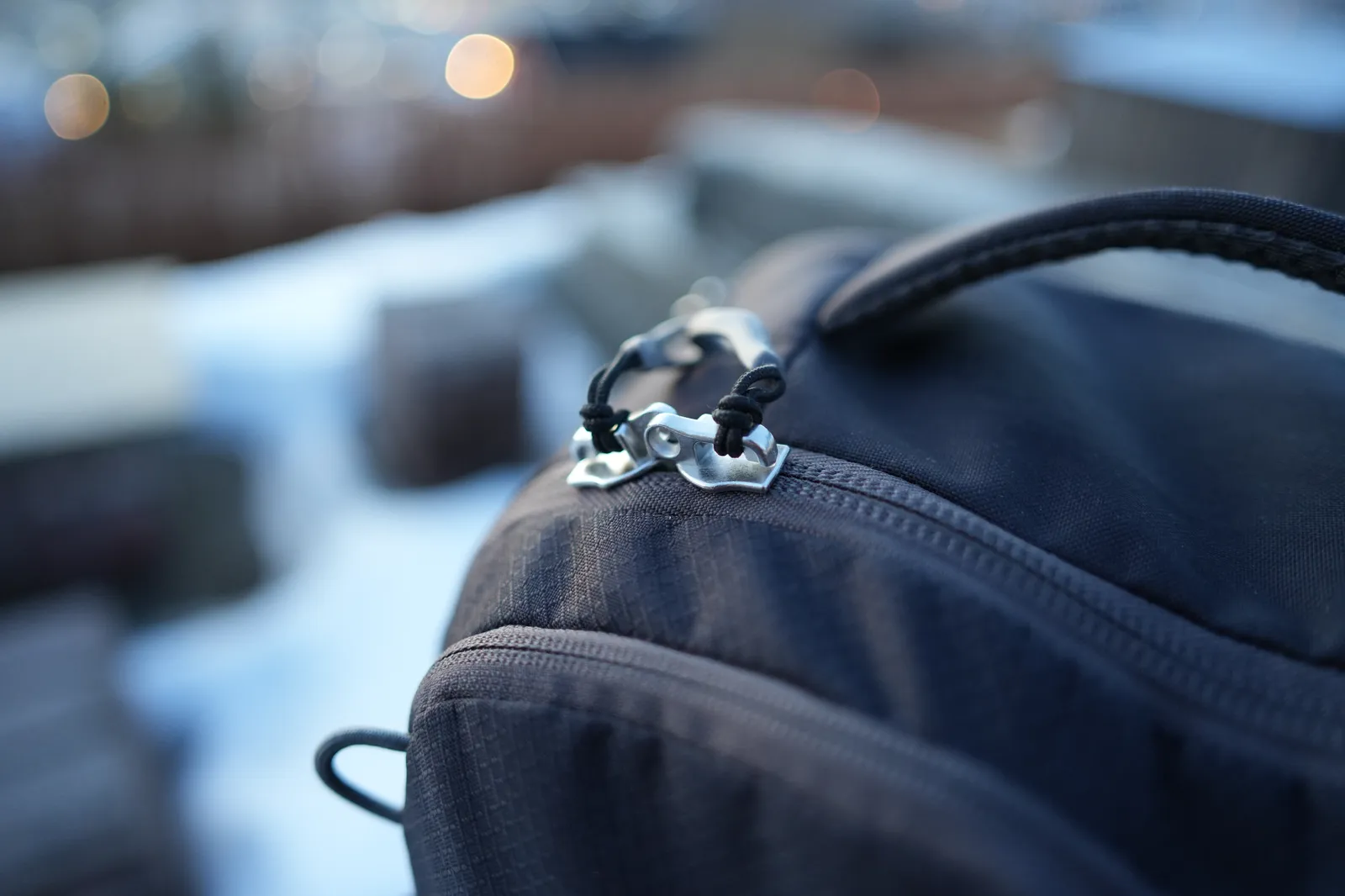 Close-up of the Osprey Daylite 35 zipper pulls showing the sturdy metal hardware and lockable design