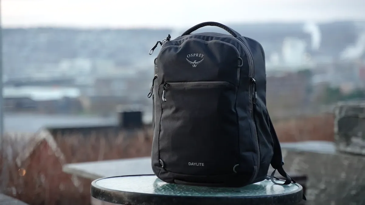Osprey Daylite 26+6 hero shot with panoramic city skyline background