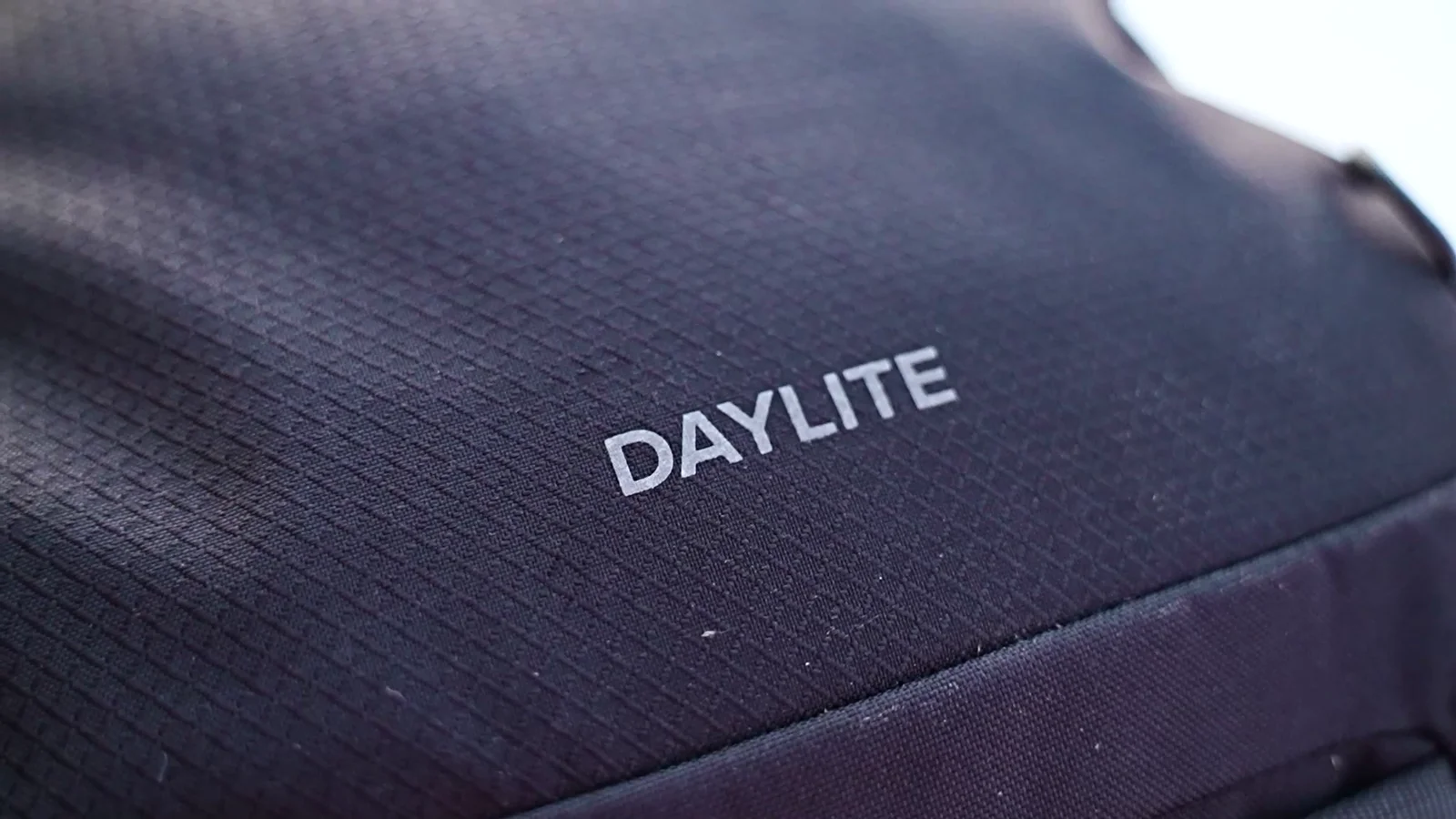 Close-up of Osprey Daylite recycled polyester fabric showing DAYLITE branding