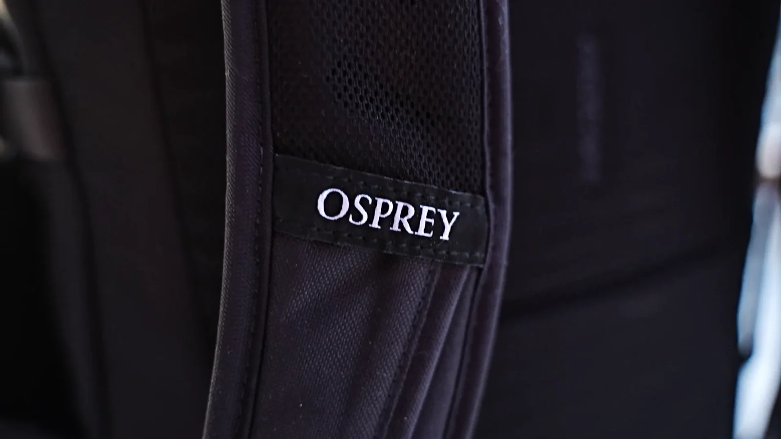 Close-up of Osprey branded shoulder strap with mesh padding